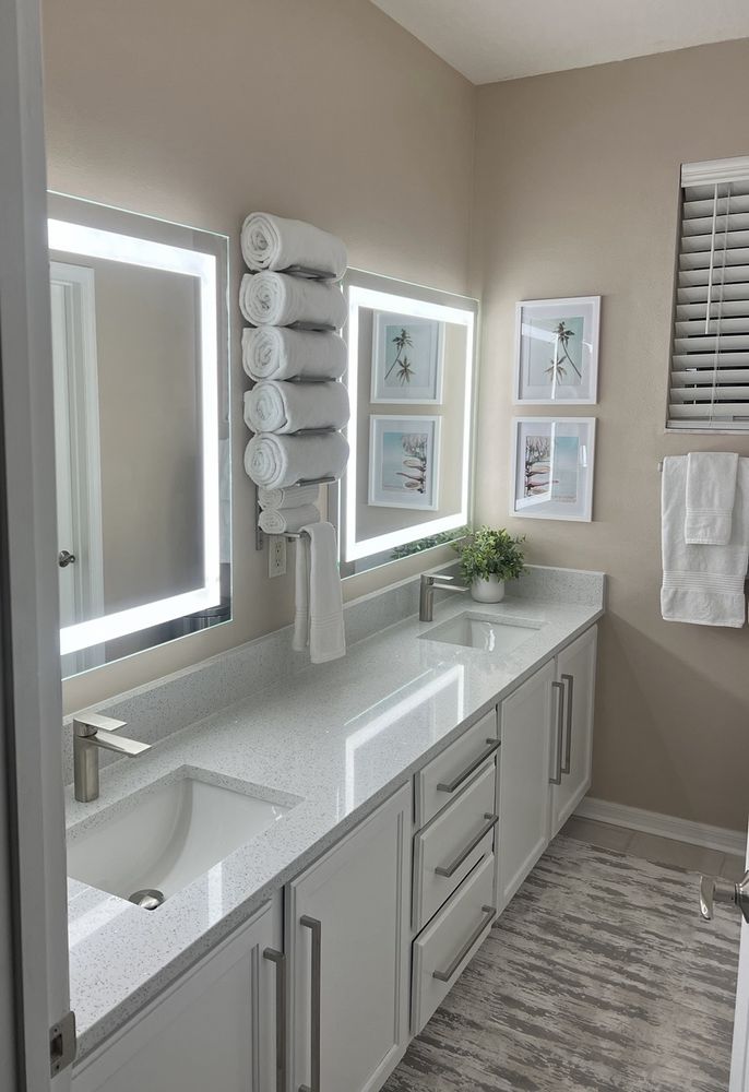 Completed bathroom remodel with double vanity and LED mirrors by Horizon Elite Renovations