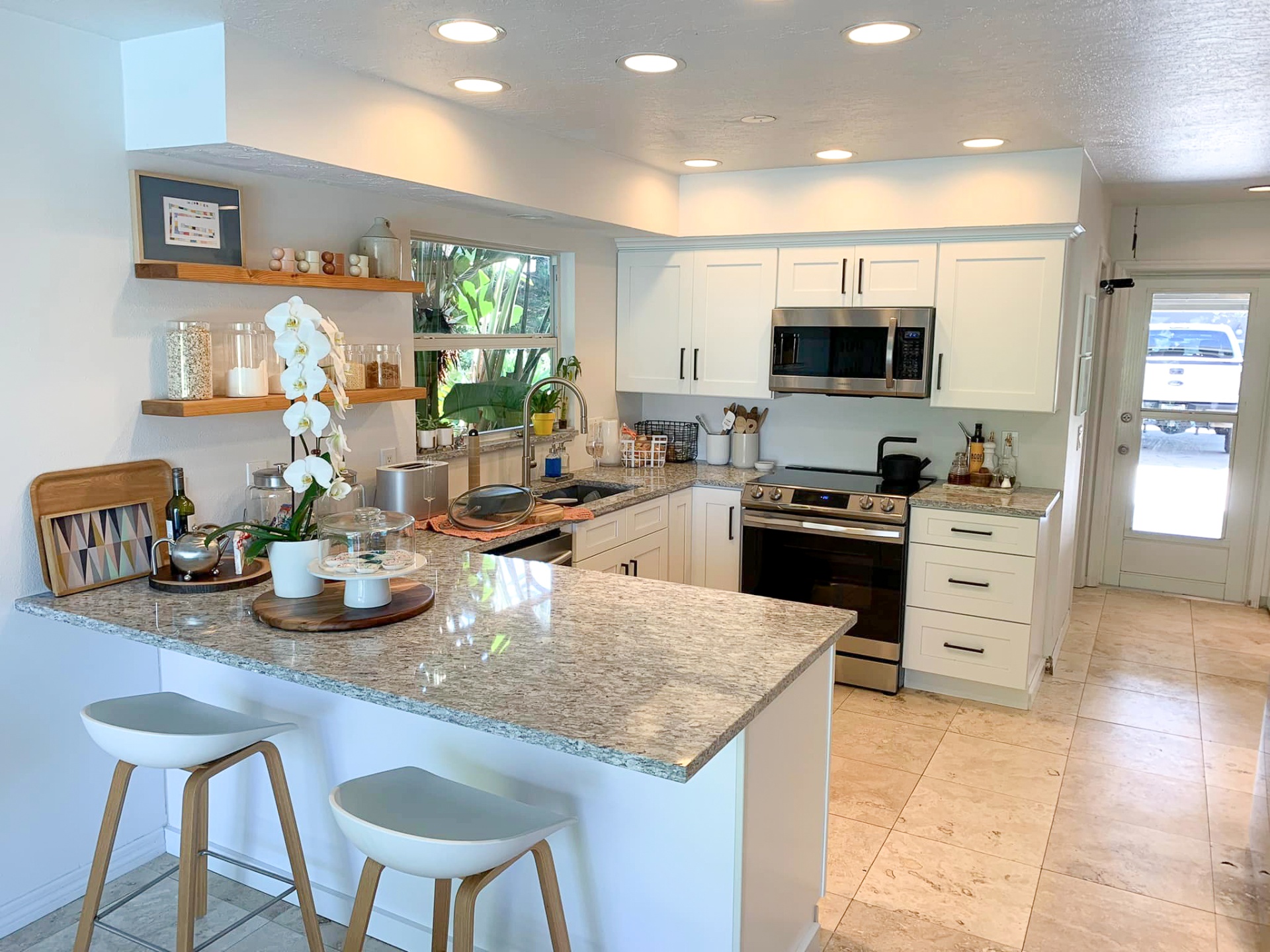 Completed white kitchen remodel with granite counters and open shelving by Horizon Elite Renovations